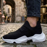 Men's black knit lace-up sneakers with white sole, front side view