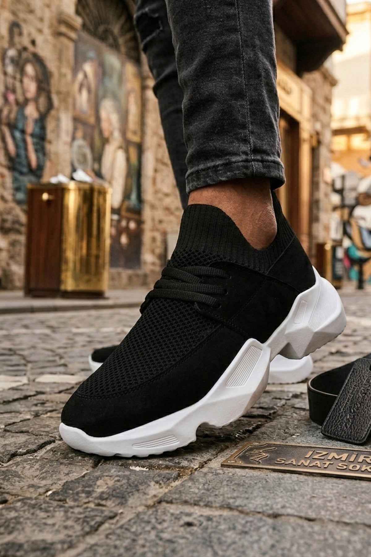 Men's black knit lace-up sneakers with white chunky sole, side view