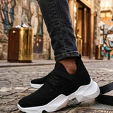 Men's black knit lace-up sneakers with white sole, angled step side view