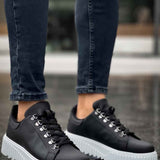 Men's black lace-up low sneakers with white ridged sole and toe cap