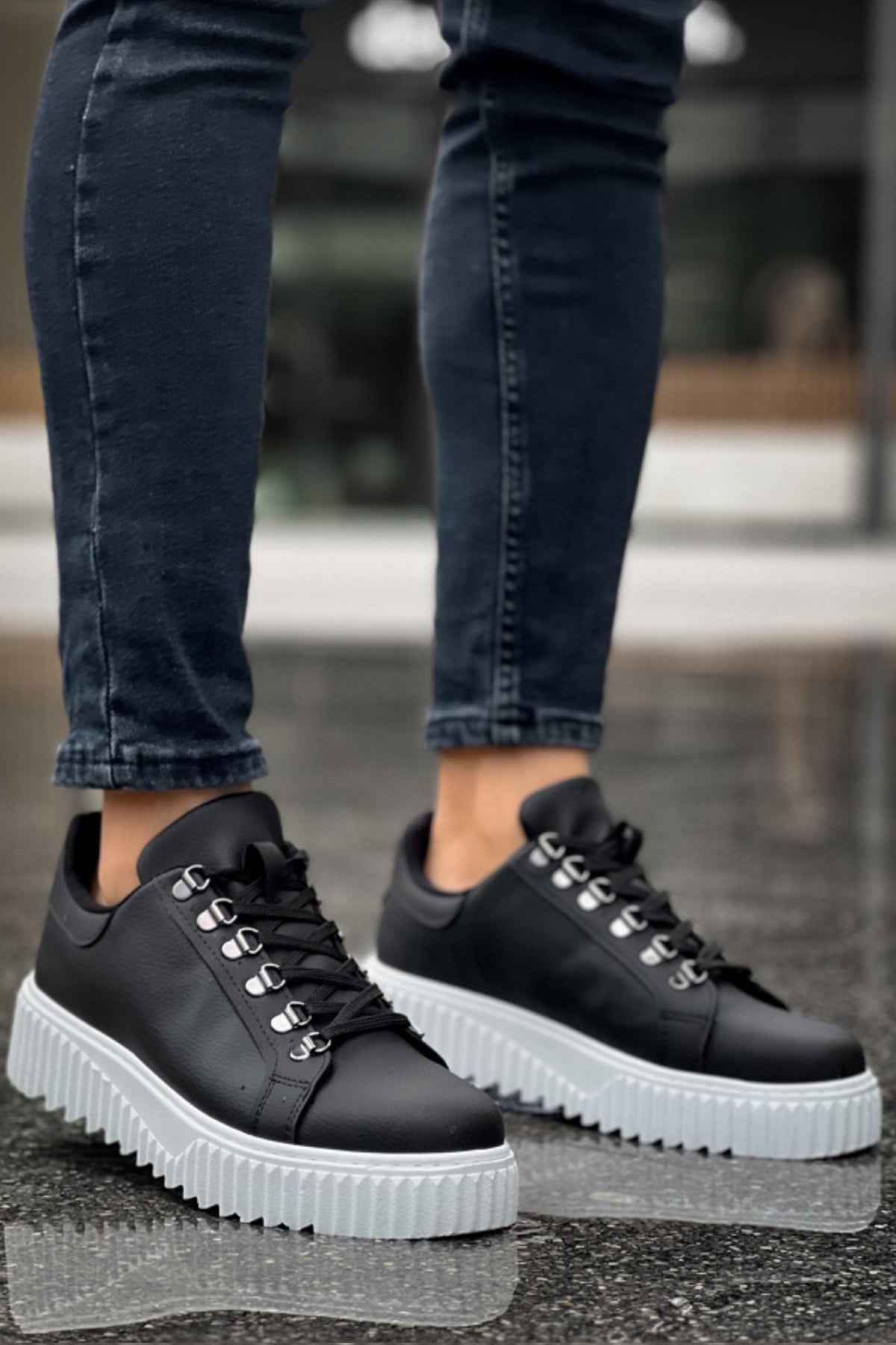 Men's black lace-up low sneakers with white ridged sole and toe cap