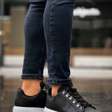 Men's black sneakers with white platform sole and lace-up closure