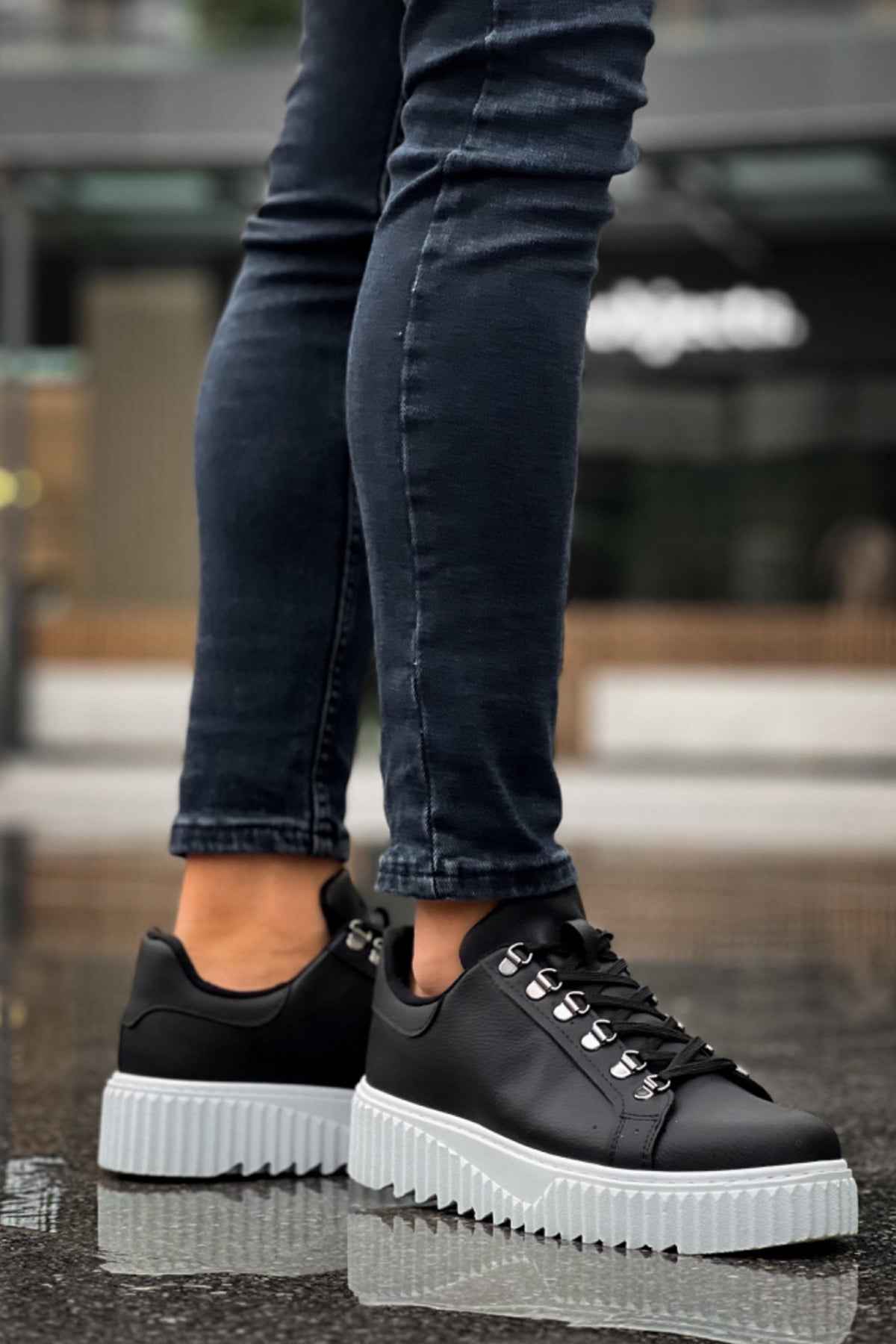 Men's black sneakers with white platform sole and lace-up closure
