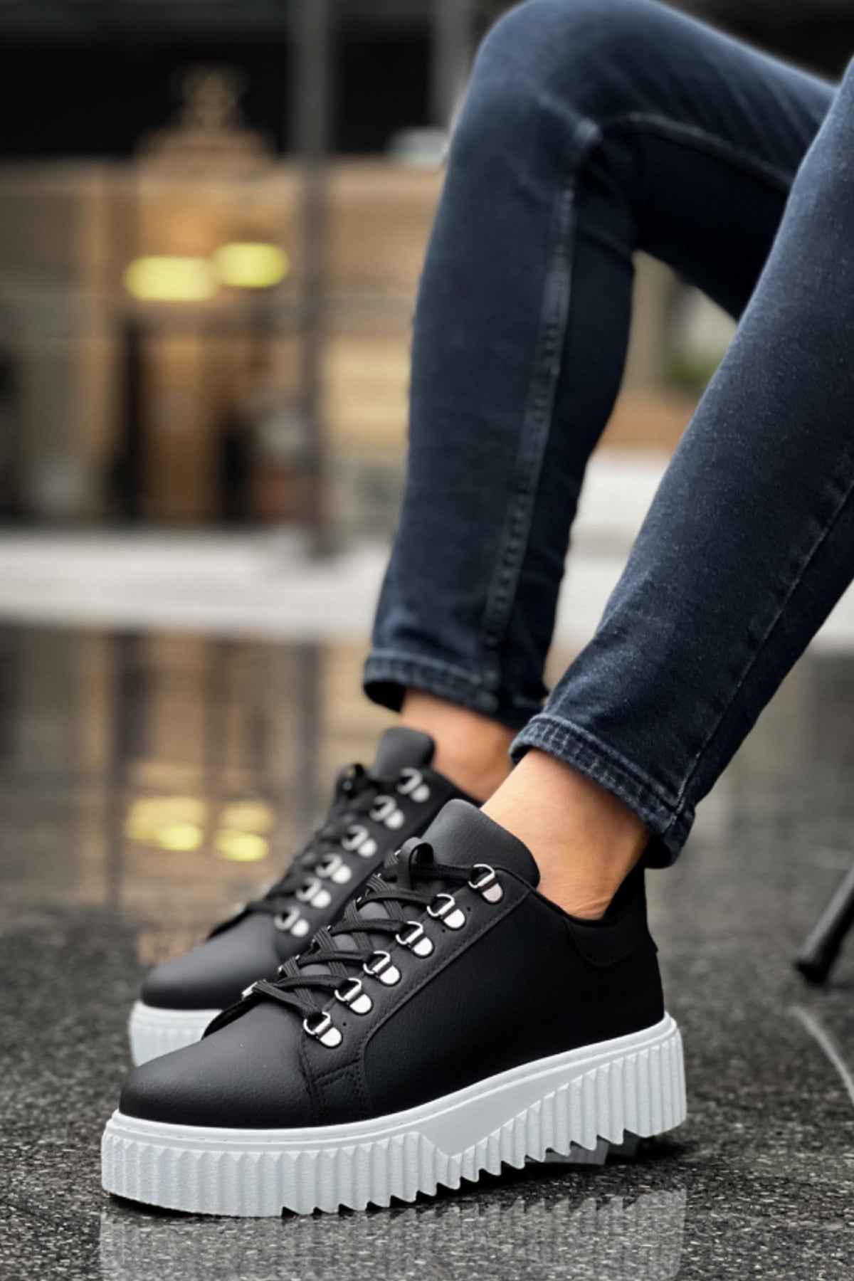 Men's black sneakers with white sole, lace-up front, and side panels