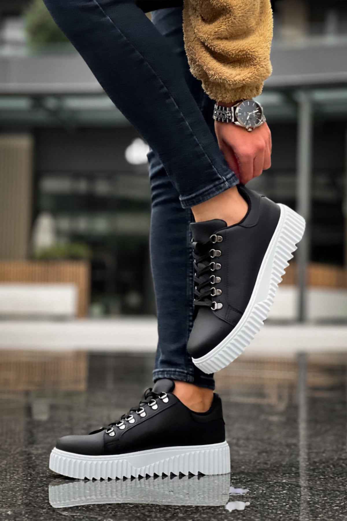 Men's black sneakers with white platform sole and lace-up eyelets, side angle