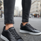 Men's black lace-up sneakers with white sole and visible stitch lines