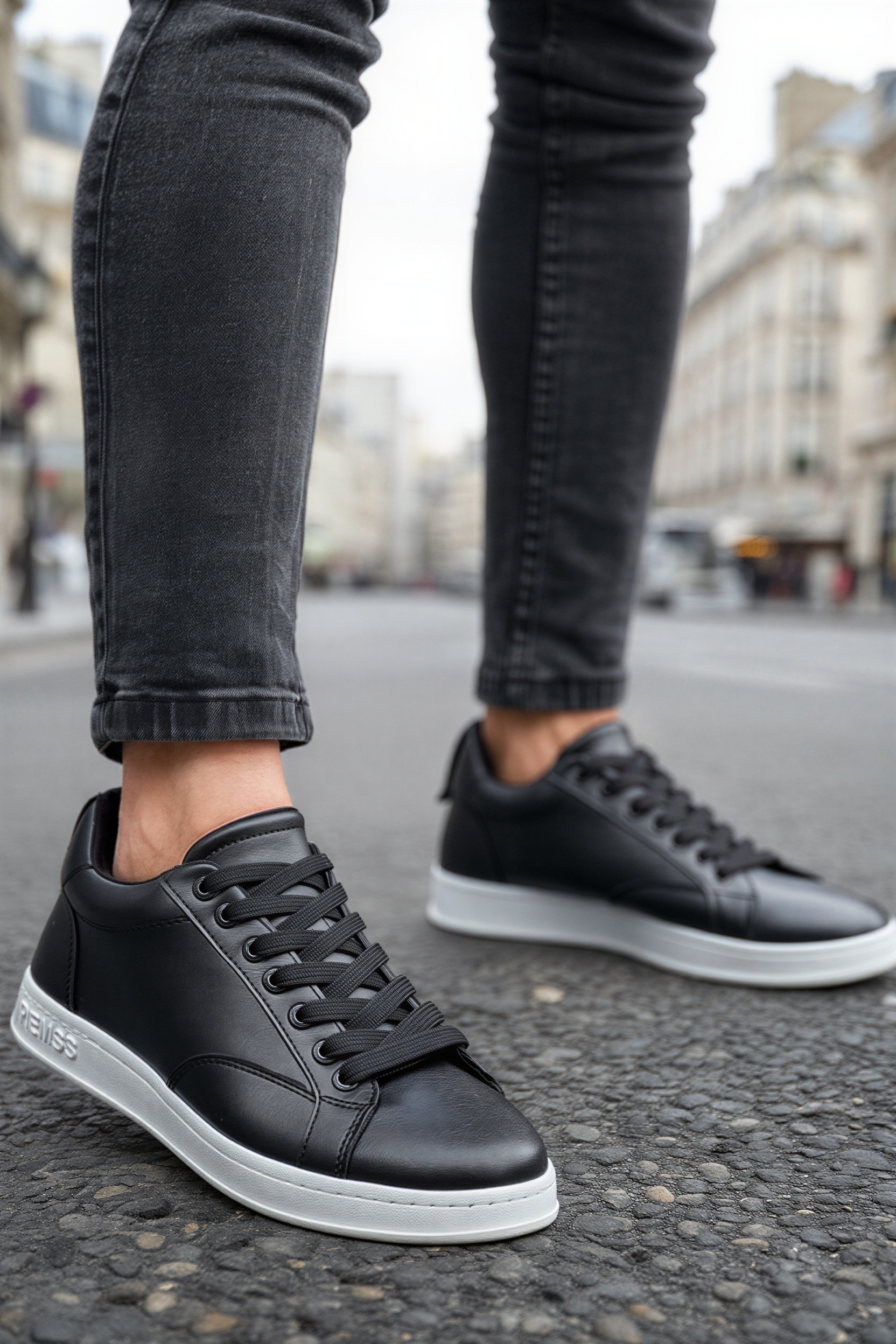 Men's black lace-up sneakers with white sole and visible stitch lines