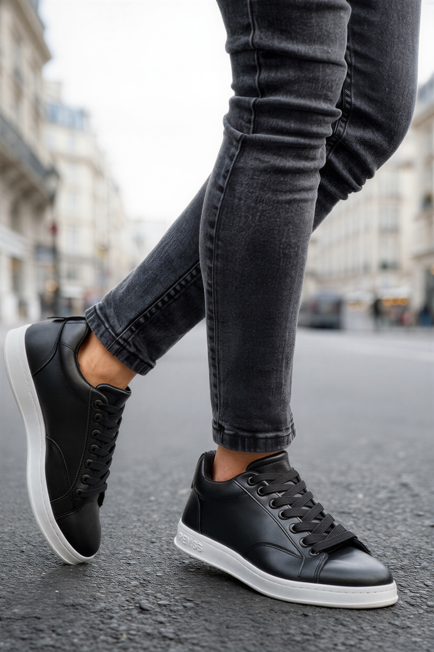 Men's black low-top lace-up sneakers with white midsole and black laces