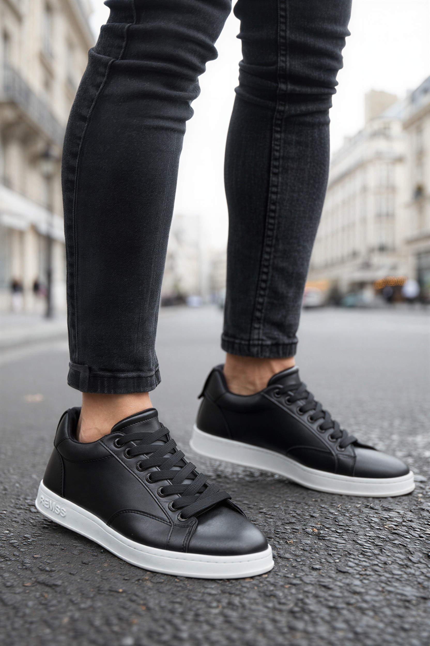 Men's black low-top lace-up sneakers with white soles and side stitching