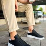 Men's black low-top sneakers with white rubber sole and lace-up design