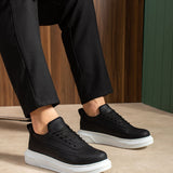 Black lace-up sneakers with white rubber sole, side view