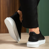 Black low-top sneakers with white sole, heel and toe detail