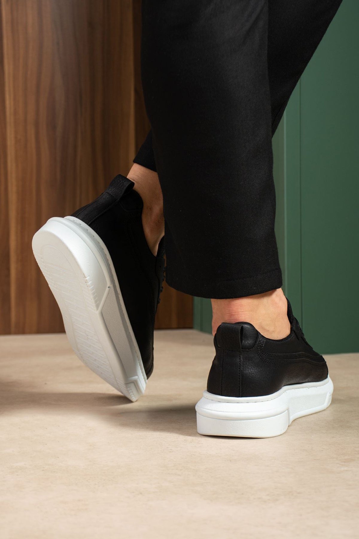 Black low-top sneakers with white sole, heel and toe detail