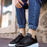 Men's black lace-up sneakers with white midsole, side view