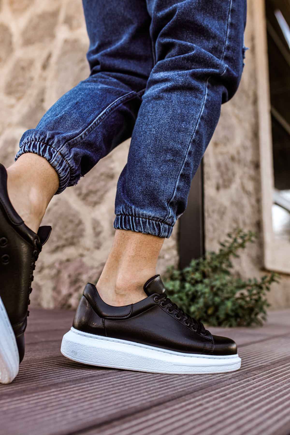 Men's black leather sneakers with white sole, angled side view