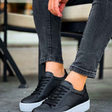 Black low-top sneakers with perforated panels, lace-up closure, and white cupsole