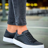 Black lace-up sneakers with perforated toe and white cupsole