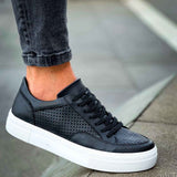 Black lace-up sneakers with perforated toe, black laces, and white rubber sole