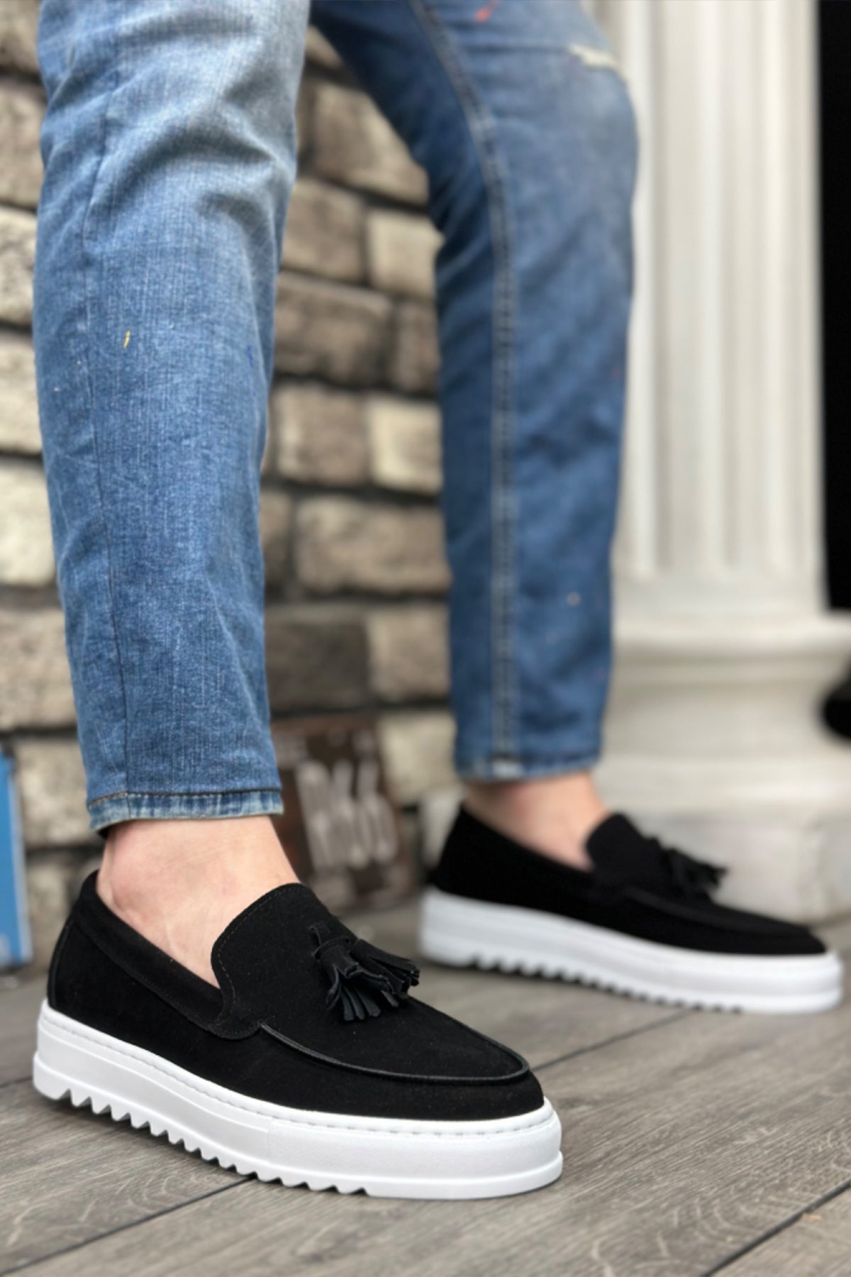 Men's black suede loafers with tassel fringe and white rubber sole