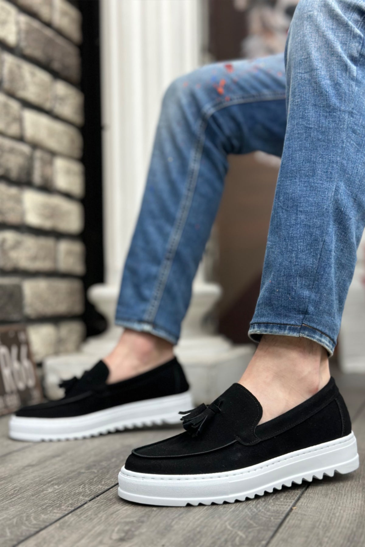 Men's black suede slip-on loafers with tassel fringe and white platform sole