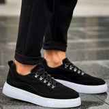 Men's black suede lace-up sneakers with white sole, angled side view