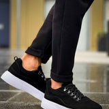 Men's black suede lace-up sneakers with white sole, low-top profile view
