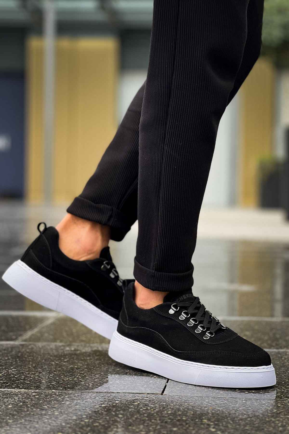 Men's black suede lace-up sneakers with white sole, low-top profile view