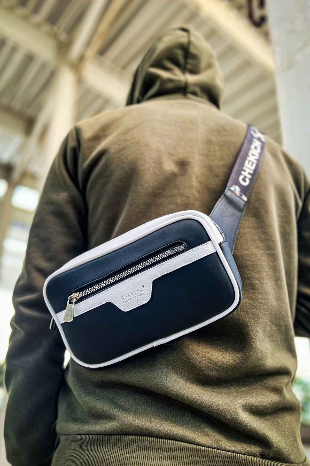 Men's tablet bag with navy and white panels, front zipper pocket and shoulder strap