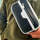 Men's tablet bag with navy and white trim, zippered front pocket, adjustable strap