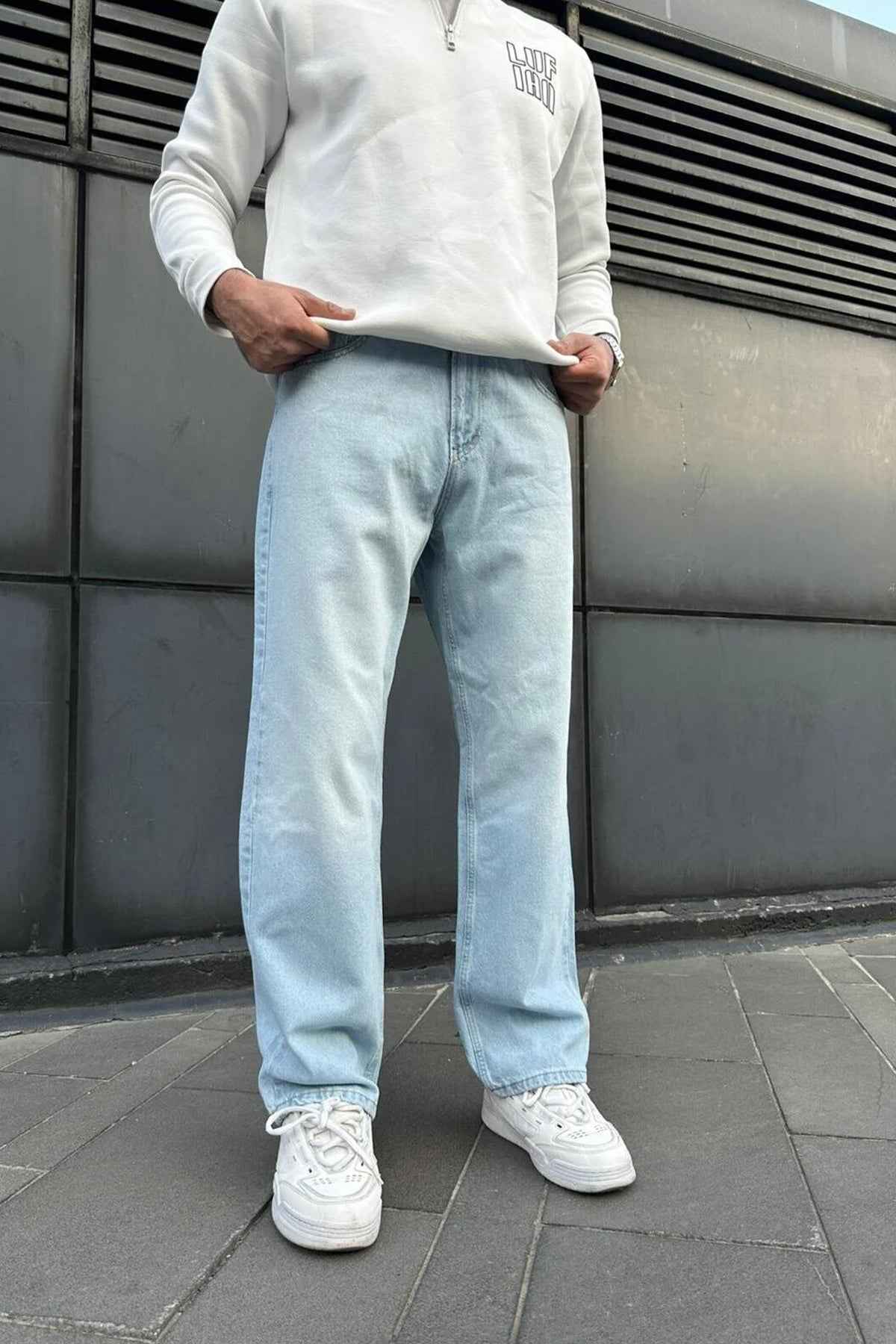 Light blue baggy jeans with relaxed straight legs and cuffed hems