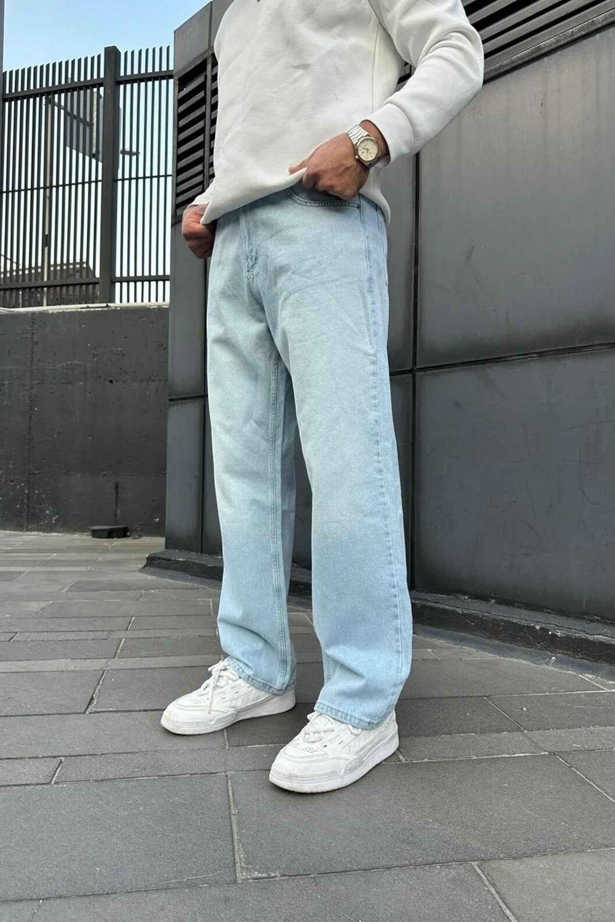 Light blue baggy jeans with wide legs, front creases, and side pockets