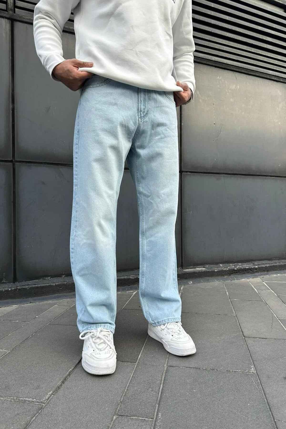 Light blue baggy jeans with relaxed fit, visible stitching, and cuffed ankle hems