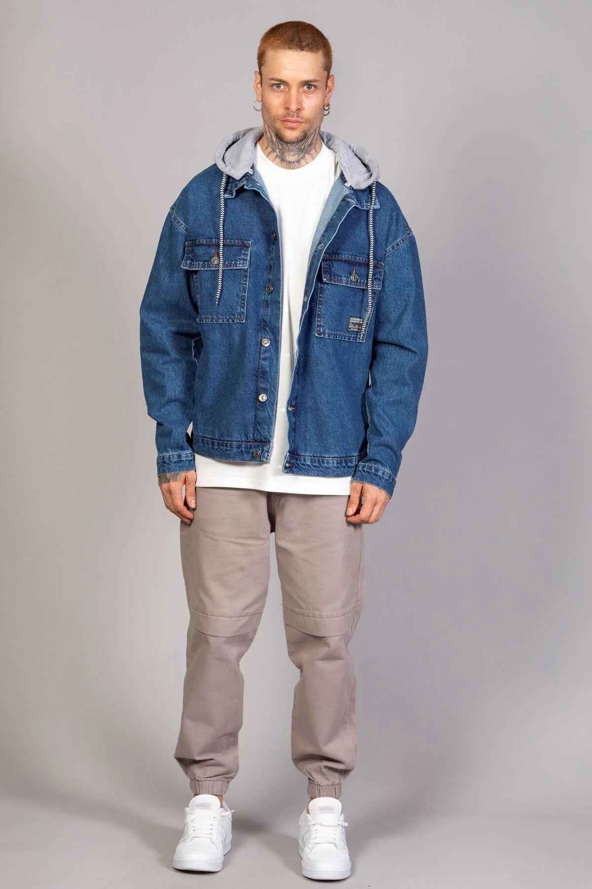 Men's blue oversized denim jacket with gray hood, front button closure, flap pockets