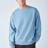Men's oversized light blue sweatshirt with crew neck and long sleeves, ribbed cuffs
