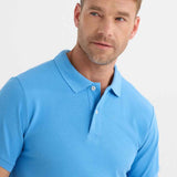 Blue polo shirt close-up with fold-over collar and visible button placket