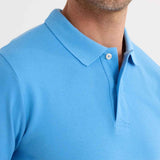 Blue polo shirt collar detail with button and stitched placket