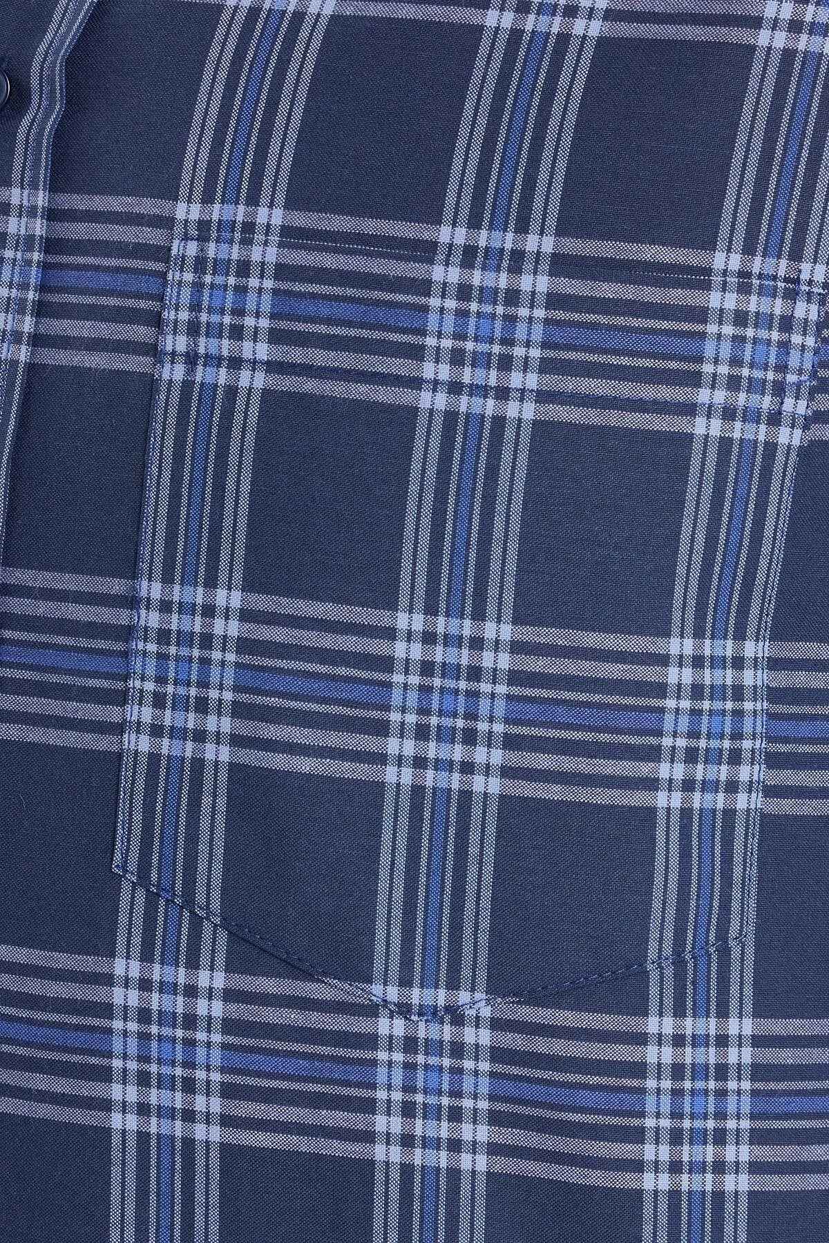 Blue plaid shirt pocket panel with stitched seam and fabric texture.