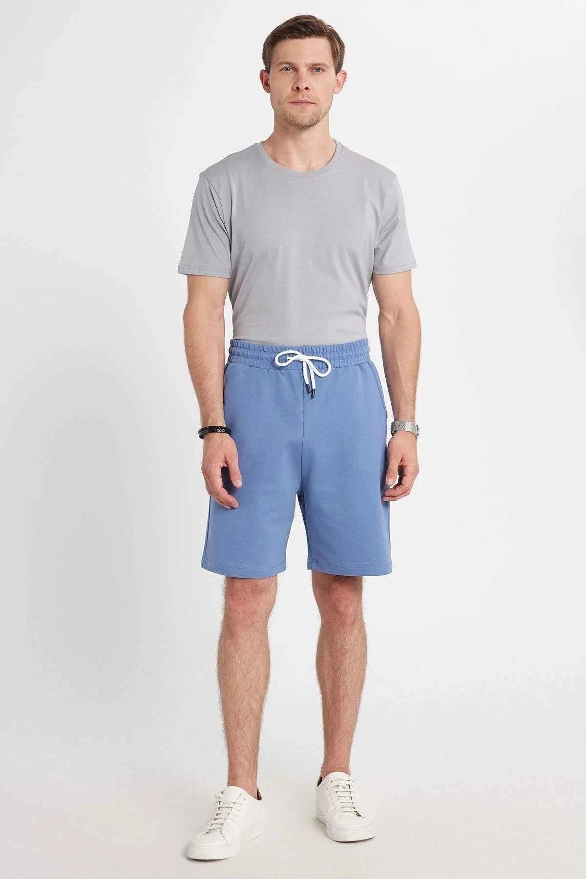 Men's blue shorts with elastic waistband and drawstring, knee-length fit