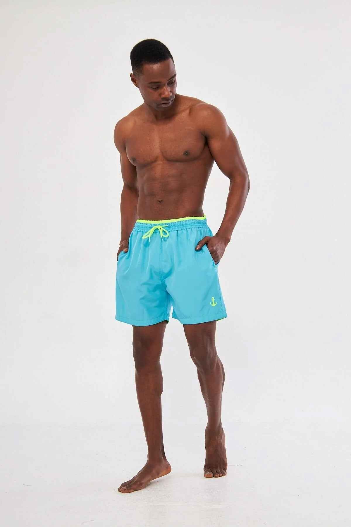 Men's blue swimming shorts with yellow drawstring and elastic waistband, side view