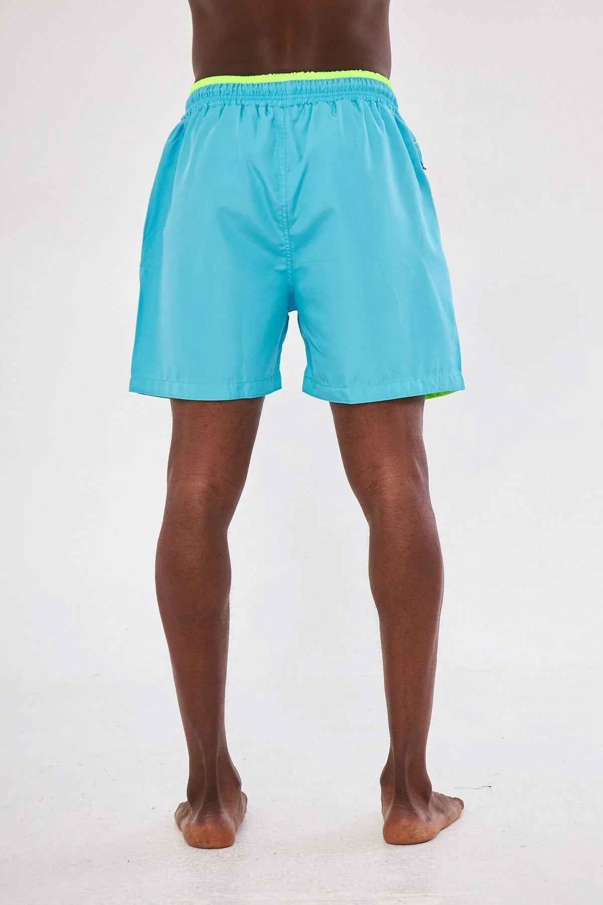 Men's blue swimming shorts with yellow elastic waistband, back view