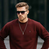 Men's maroon crewneck sweatshirt with small chest logo, hands on waist, long sleeves