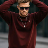 Men's maroon basic sweatshirt with small chest logo, crew neck, raised arms