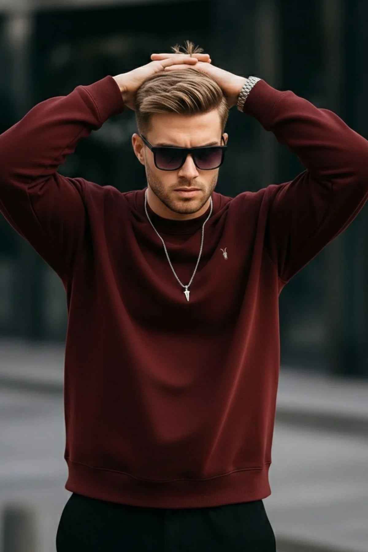Men's maroon basic sweatshirt with small chest logo, crew neck, raised arms
