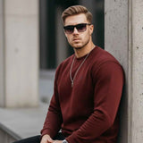 Men's maroon sweatshirt with small chest logo, crew neck, long sleeves, side pose