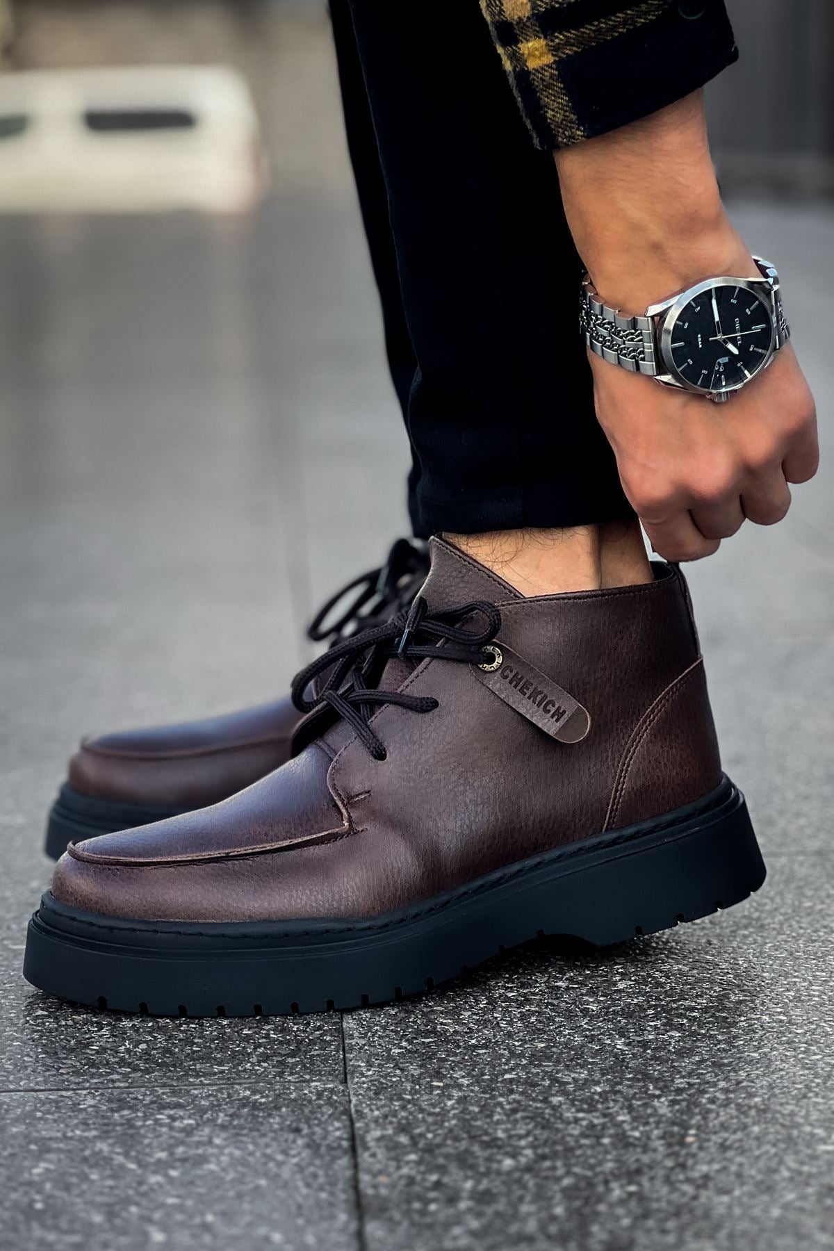 Men's dark brown lace-up ankle boot with side logo patch and thick tread sole