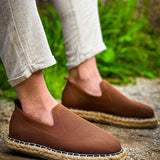 Brown espadrille slip-on shoes with textured fabric upper and jute sole