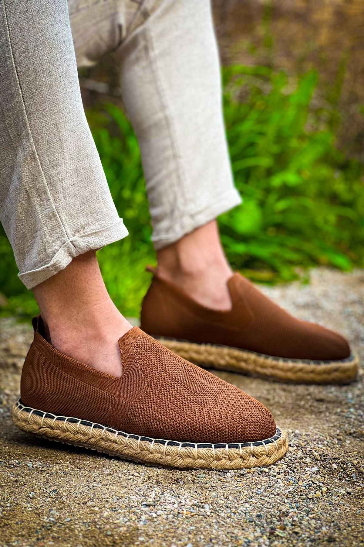 Brown espadrille slip-on shoes with textured fabric upper and jute sole