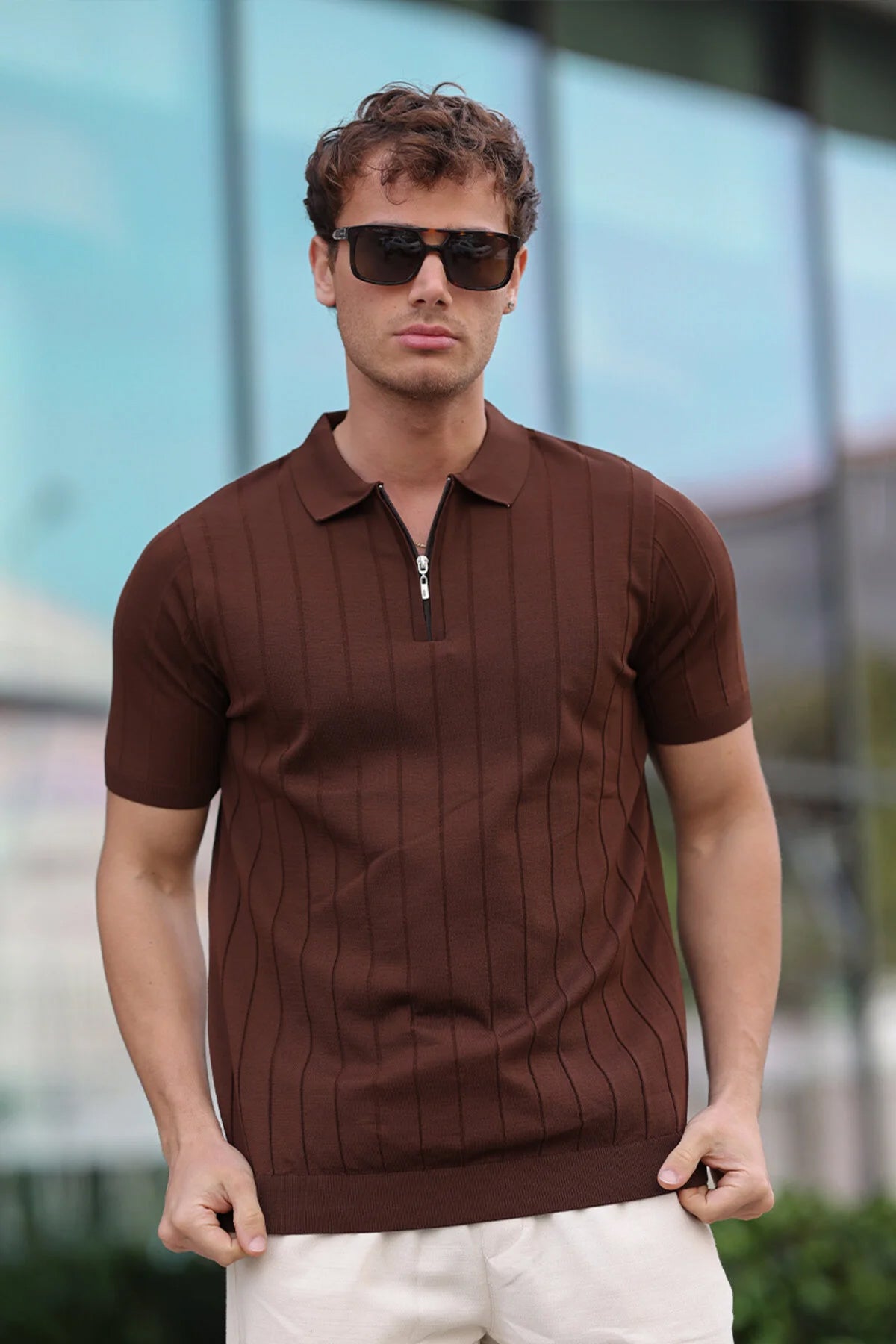 Brown half-zip polo shirt with short sleeves and vertical ribbed stripe pattern, collared