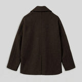 Dark brown oversized double-breasted coat, back view with center seam.