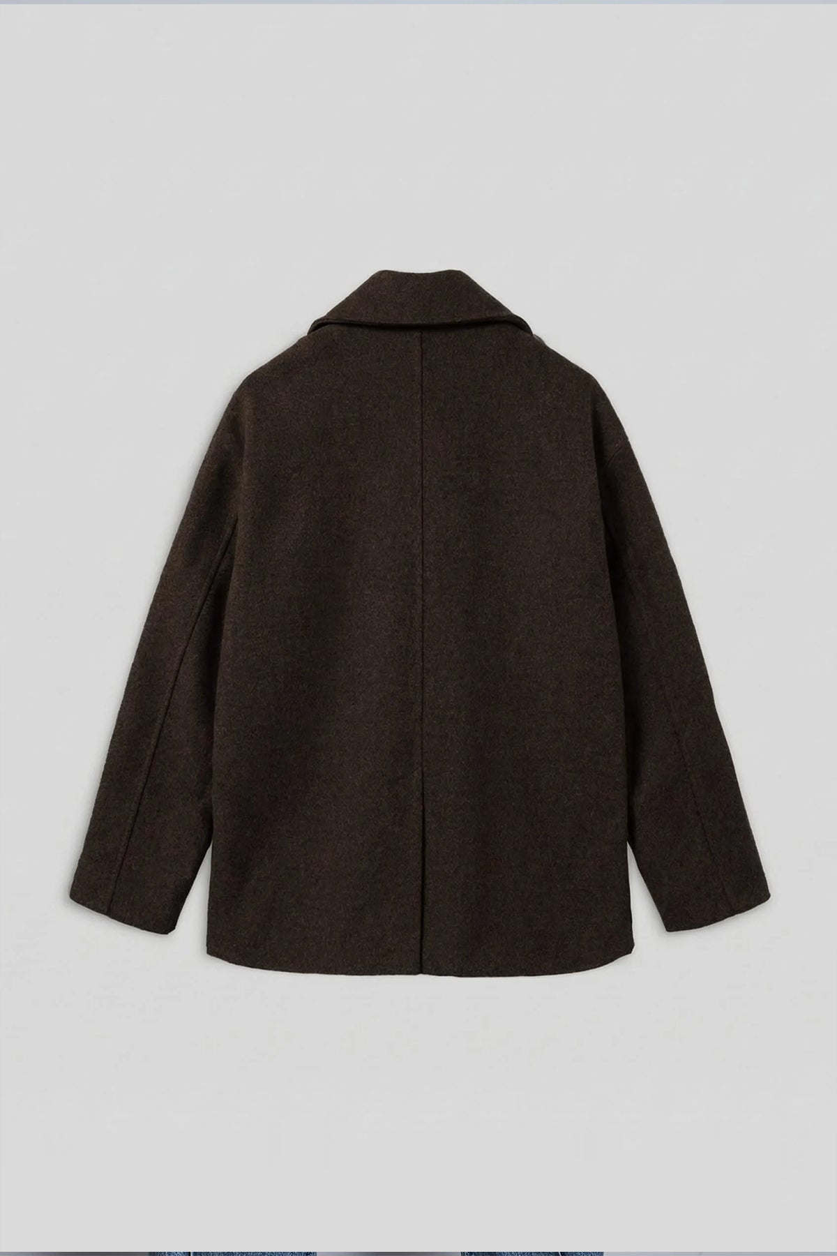 Dark brown oversized double-breasted coat, back view with center seam.
